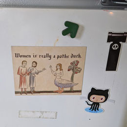 Paths duck postcard magnet on a fridge with a GitHub sticker